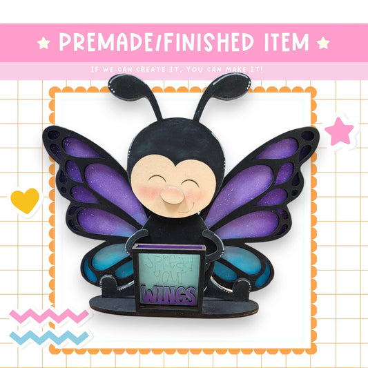 a paper craft of a butterfly holding a computer