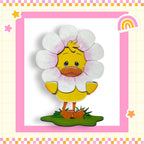 A cartoon duck wearing a flower costume, standing on a green surface with a pink and yellow border.
