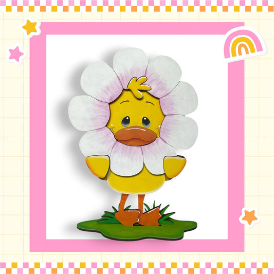 A cartoon duck wearing a flower costume, standing on a green surface with a pink and yellow border.