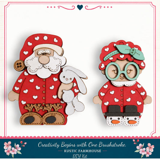 two wooden cutouts of Santa Claus and a young girl, both wearing red and white polka dot outfits with a red bow on their heads.