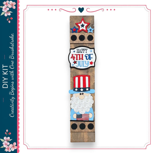 A vertical wooden sign with patriotic decorations, including a star, a red and white striped hat, and an American flag, along with the text "Happy 4th of July".