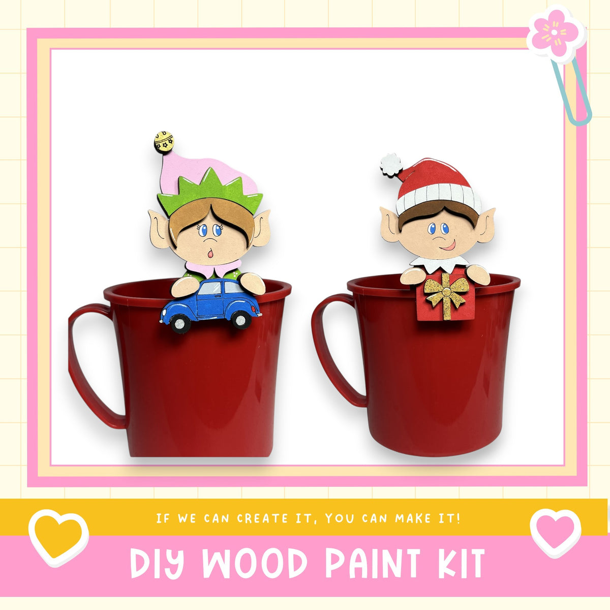 two elf figurines, one sitting in a red mug and the other in a red mug, both wearing Santa hats. The image also includes text that says "If we can create it, you can make it!" and "DIY WOOD PAINT KIT".