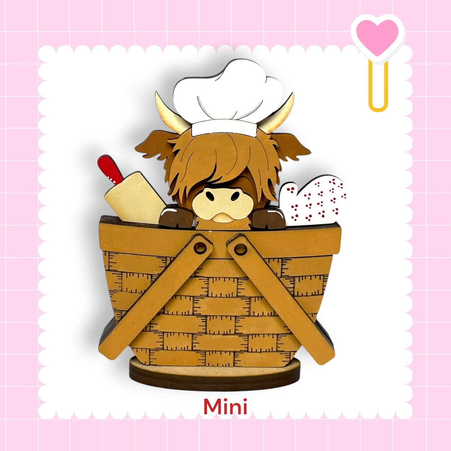 A cartoon illustration of a cow wearing a chef's hat and holding a rolling pin, sitting in a basket.