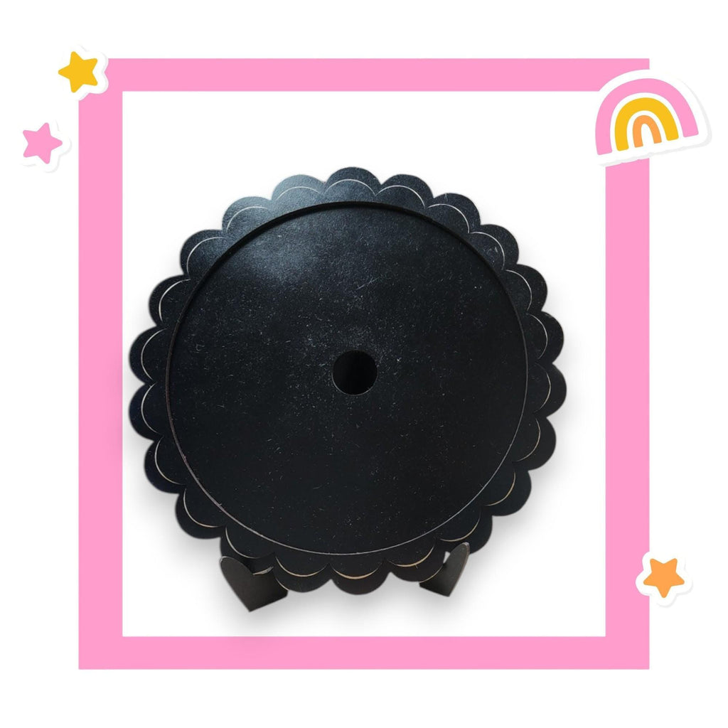 a picture of a round black object with a rainbow in the background