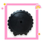 a picture of a round black object with a rainbow in the background