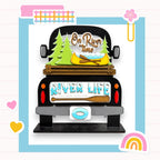 a black truck with a wooden bed, decorated with various objects related to river life, such as a canoe, pine trees, and a sign that says "On River Time".