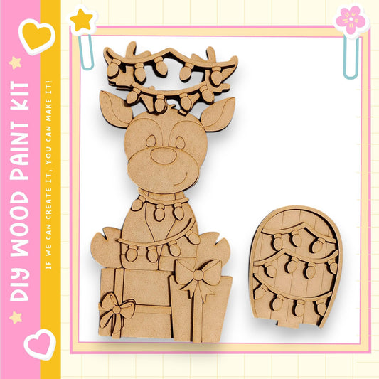 A wooden deer figurine with a bow and a small wooden box with lights on it, both set against a pink and yellow background.