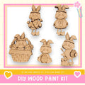 The image is a DIY wood paint kit featuring five wooden Easter bunny characters in various poses, including one in a basket, one holding an egg, and one holding a paintbrush.
