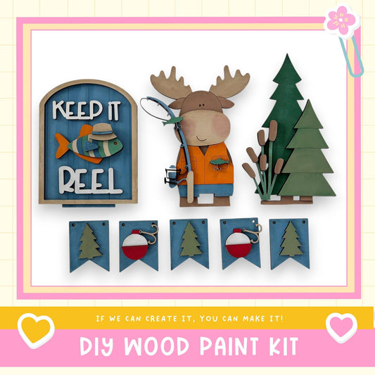 The image is a collage of various wooden craft items, including a moose figure, a fishing rod, and a tree, along with a sign that says "Keep it Reel". The collage also includes a banner with the text "If we can create it, you can make it!" and a heart symbol.