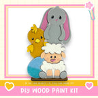 a DIY wood paint kit with a colorful and whimsical design, including a rabbit, a chicken, and a sheep.