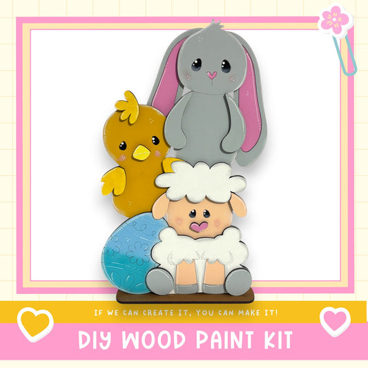 a DIY wood paint kit with a colorful and whimsical design, including a rabbit, a chicken, and a sheep.