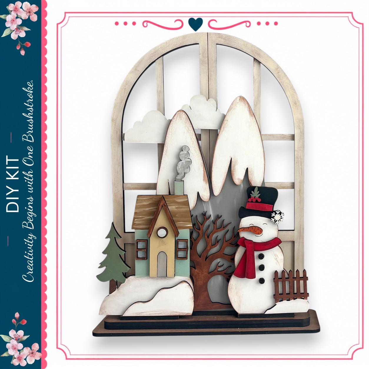 A wooden snowman stands in front of a window, with a small house and tree visible through the window.