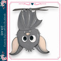 A cute gray bat with large eyes and a pink nose is hanging upside down from a branch, surrounded by a decorative border.