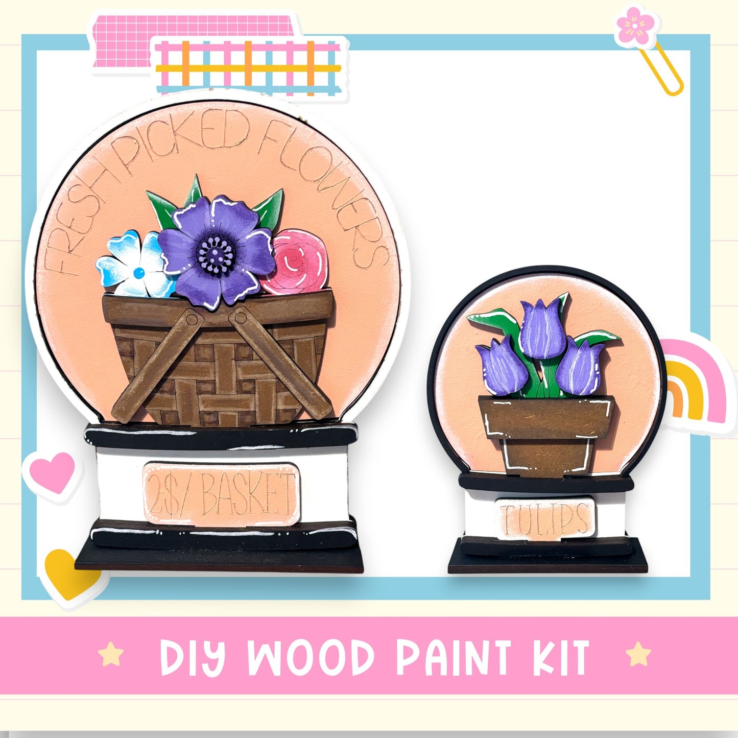 The image is a DIY wood paint kit featuring two wooden baskets with flowers, one larger and one smaller, set against a light blue background with a pink border.