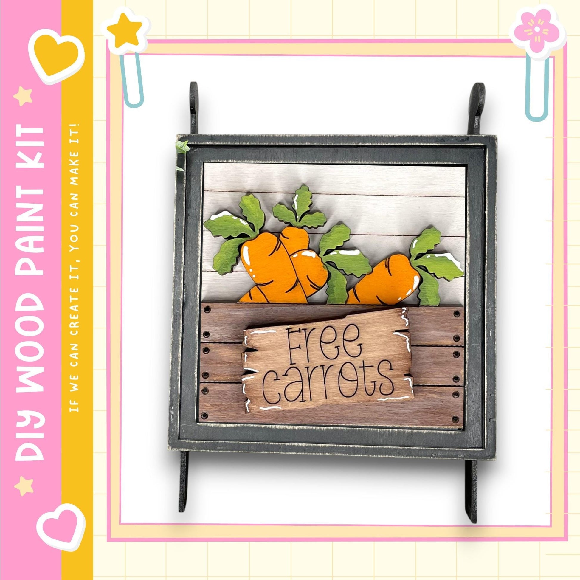 A wooden sign with the text "Free Carrots" is displayed in a wooden crate, surrounded by painted carrots.