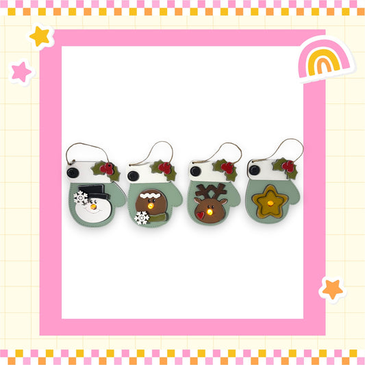 A row of four festive mittens with various holiday-themed decorations, including a snowman, reindeer, star, and bow, all set against a pink and yellow checkered background.