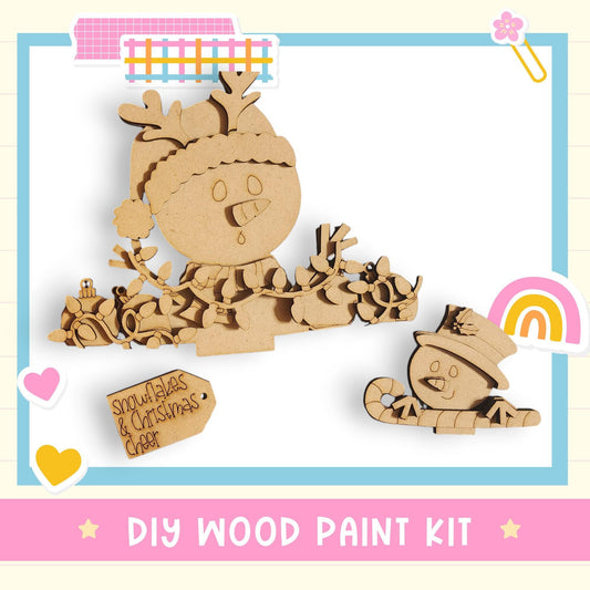a DIY wood paint kit for creating wooden snowmen and other Christmas-themed decorations.