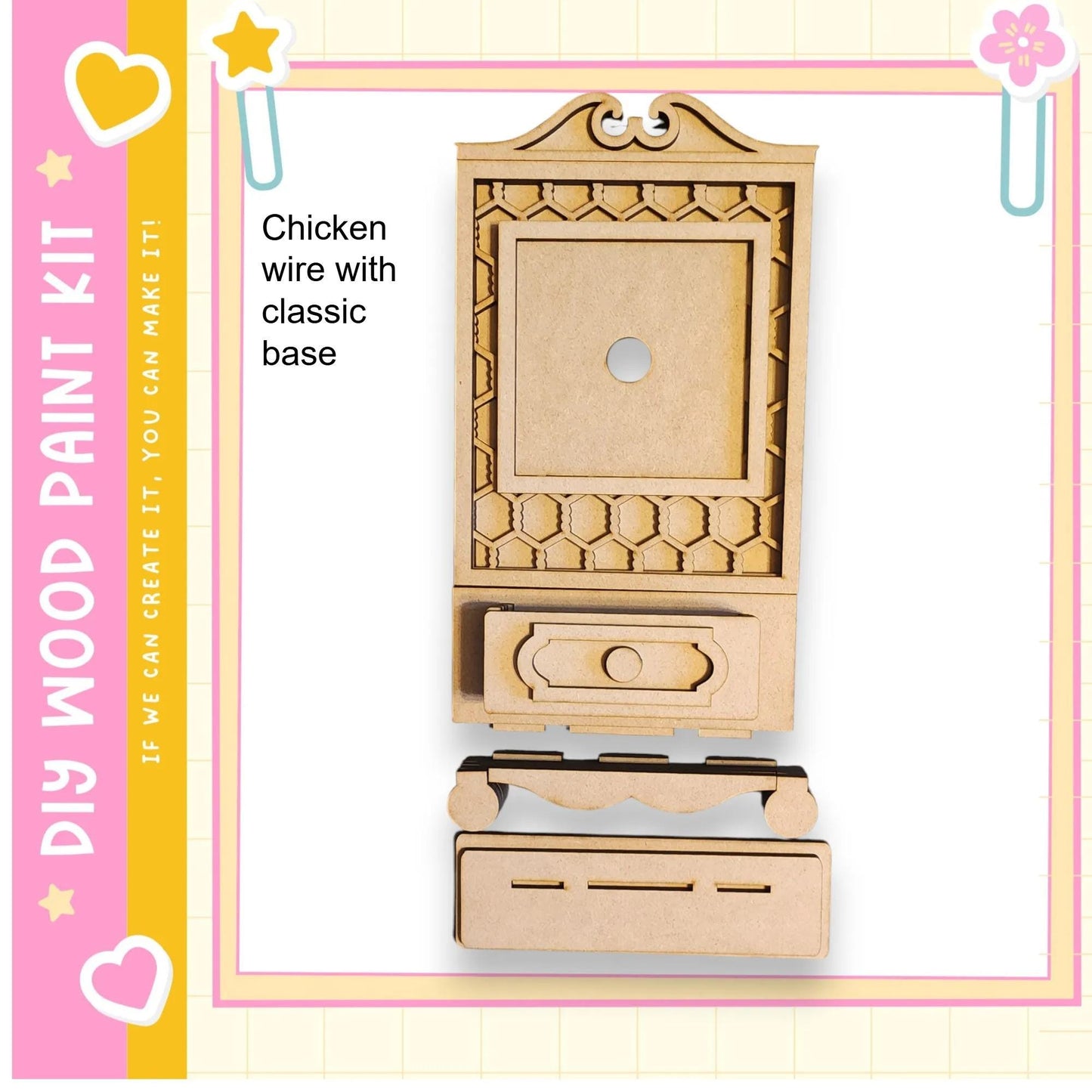 a wooden cabinet kit, which appears to be a DIY project. The kit includes a wooden frame and a drawer, as well as a decorative element on the front. The kit is presented in a pink and yellow color scheme, with a heart and star motif on the left side.