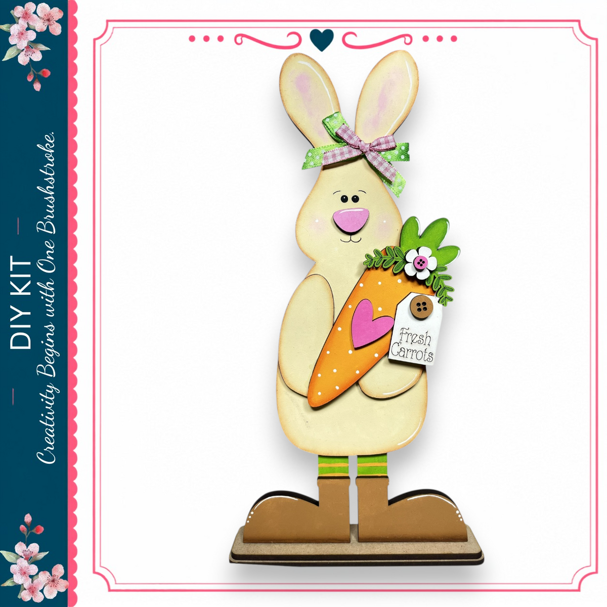 A wooden rabbit figurine holding a carrot and wearing a bow, standing on a wooden base.