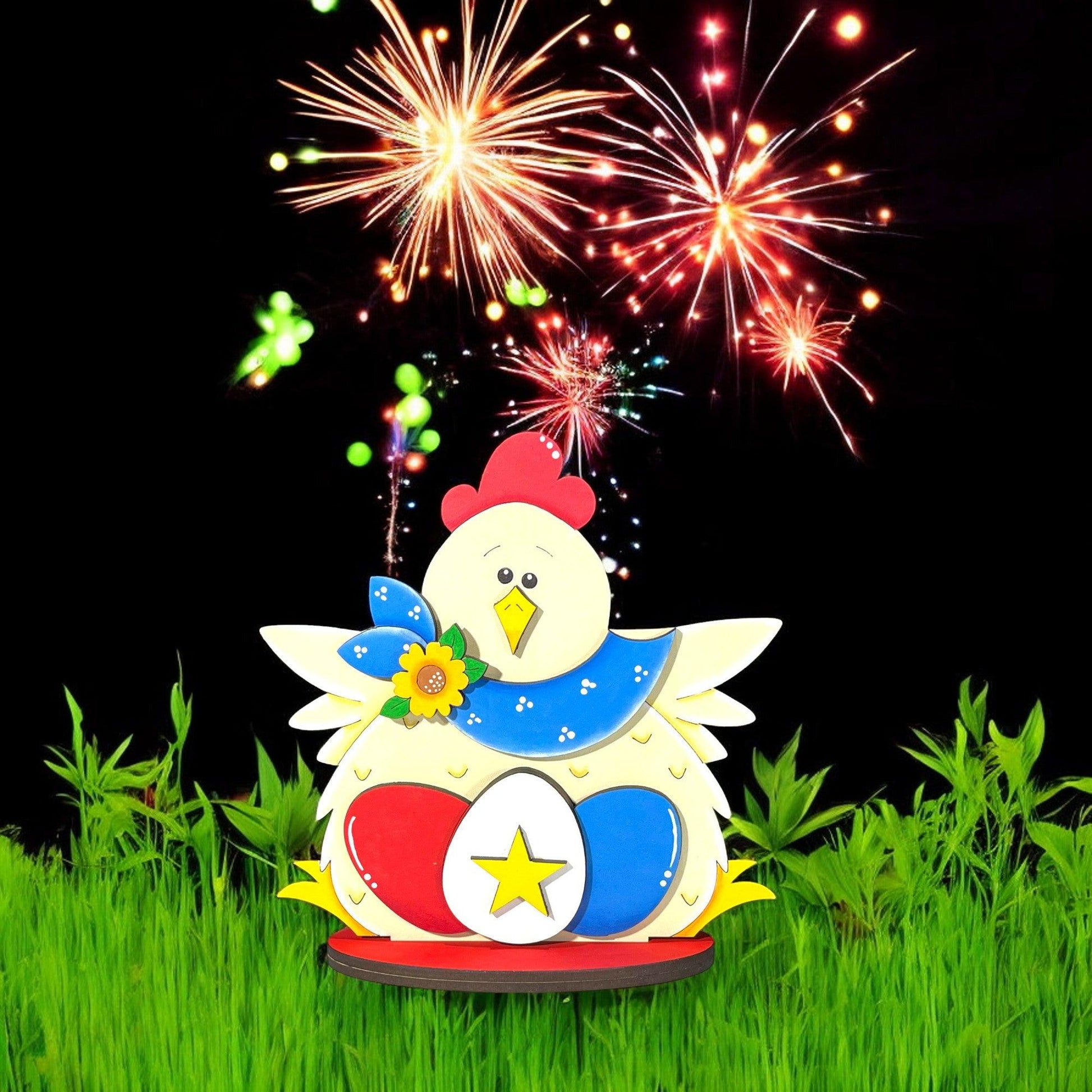 a chicken is sitting in the grass with fireworks in the background