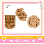 The image is a DIY wood paint kit advertisement, featuring three wooden shapes with text and a heart symbol.