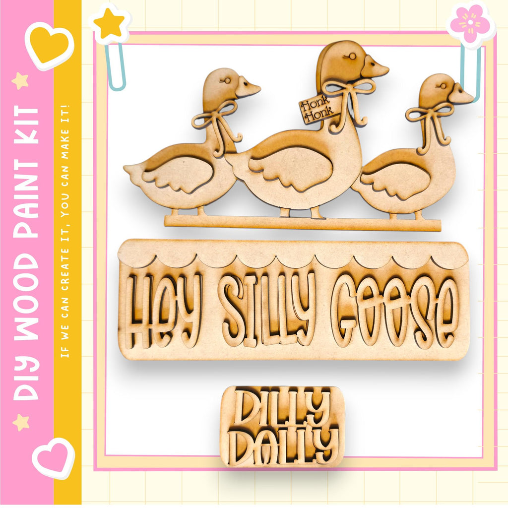a wooden cutout of three wooden ducks, with the text "Hey Silly Goose" carved into the ducks.