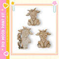 three wooden animal figurines, including a cow, a goat, and a sheep, arranged in a frame.