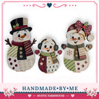three handmade snowman decorations, each with unique features and accessories, arranged in a row.