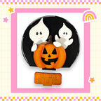 A Halloween-themed image featuring a carved pumpkin with a carved face, surrounded by two ghostly figures, and a sign that says "Just here for the boos".