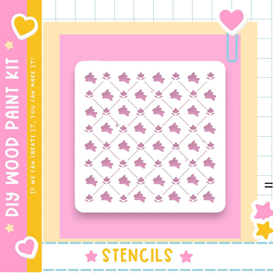 The image is a colorful and playful DIY paint kit featuring a square stencil with a repeating pattern of pink flowers against a pink background.