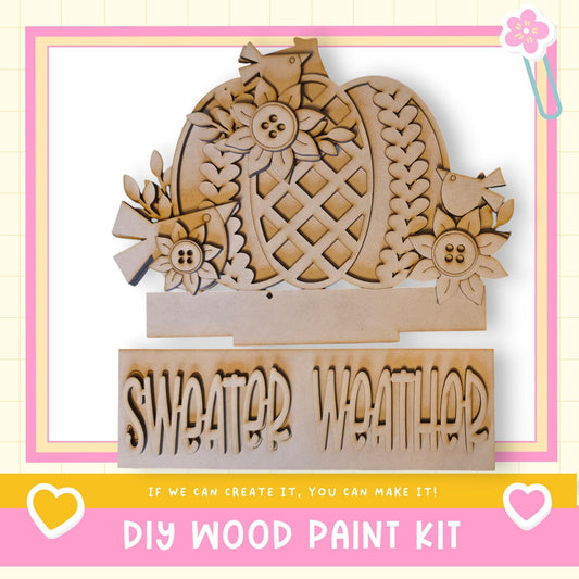 The image is a DIY wood paint kit for creating a sweater weather sign.