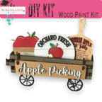 a wooden craft kit with apples in a wagon