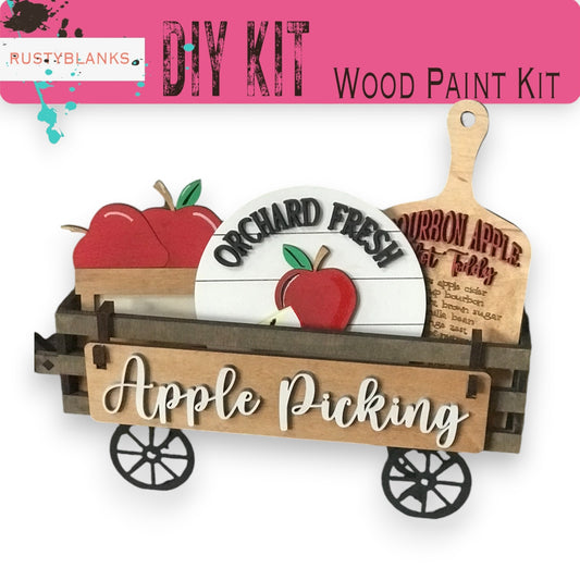 a wooden craft kit with apples in a wagon