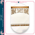 a wooden sign with the text "HOME SWEET HOME" written on it. The sign is hanging on a wall and appears to be a DIY kit.
