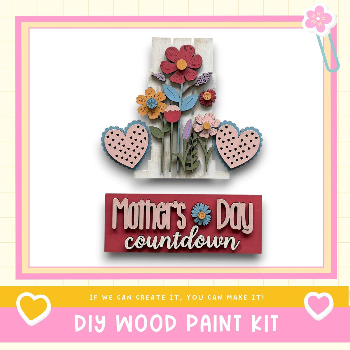 The image is a colorful and decorative Mother's Day countdown sign, featuring a variety of flowers and hearts in shades of pink, blue, and yellow. The sign is framed by a pink border and includes the text "Mother's Day countdown" and "DIY WOOD PAINT KIT" along with a heart symbol.
