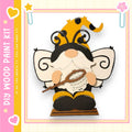 A whimsical wooden gnome figure with a bee-like appearance, holding a net and wearing a hat with a yellow and black pattern.