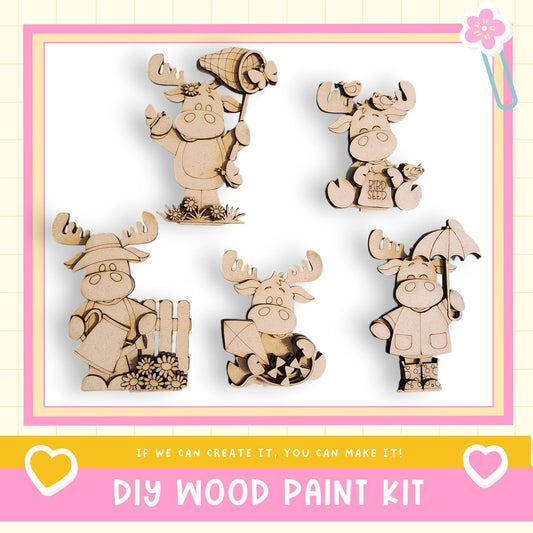 a DIY wood paint kit with five wooden animal figurines, including moose, deer, and other woodland creatures, each holding various objects such as a hat, umbrella, and flower.