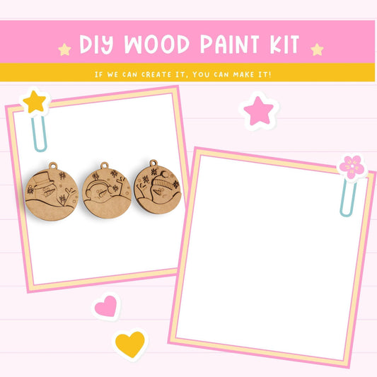 The image is a DIY wood paint kit advertisement, featuring a pink background with a yellow and white striped border. The kit includes wooden ornaments and a blank frame, suggesting it can be used to create personalized decorations. The text "DIY WOOD PAINT KIT" is prominently displayed, along with a motivational message encouraging creativity and the ability to make one's own creations.