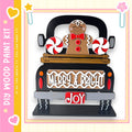 A black truck with a gingerbread man and candy decorations, including red and white striped candy canes, on the back.