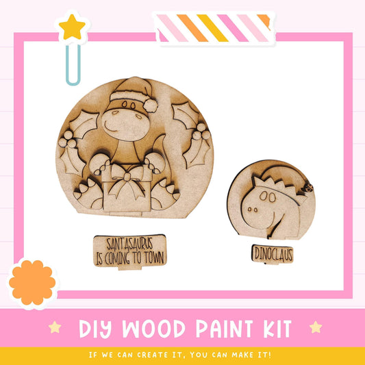 a DIY wood paint kit for creating wooden figures, including a Santa Claus figure and a dinosaur figure. The kit includes a label that reads "DIY WOOD PAINT KIT" and a smaller label that says "DINOCLAW". The kit appears to be designed for children to engage in a creative and fun activity.
