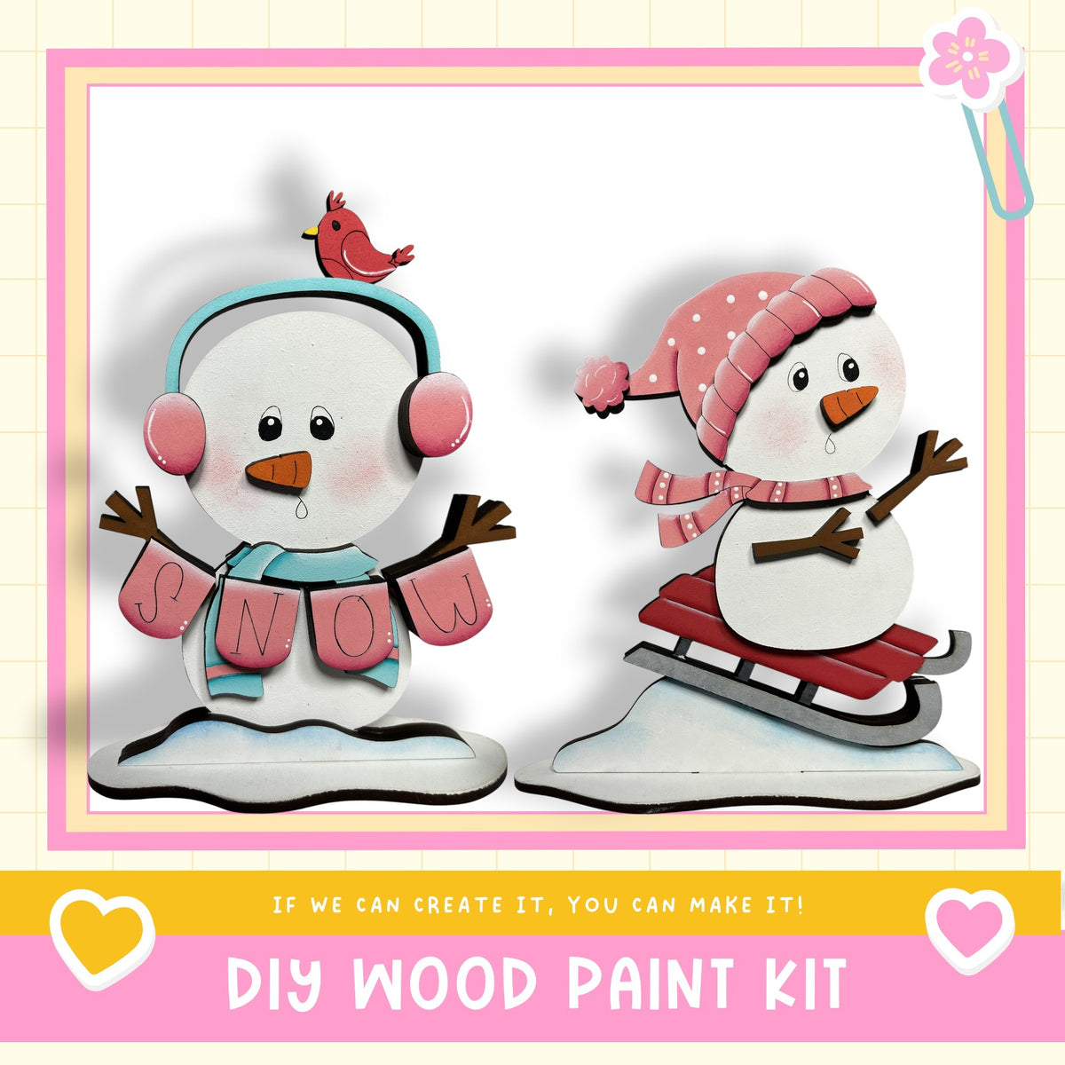 two wooden snowmen, one wearing a pink hat and the other wearing a blue hat, both holding snow-themed signs. The text below the image reads "DIY WOOD PAINT KIT" and "If we can create it, you can make it!"
