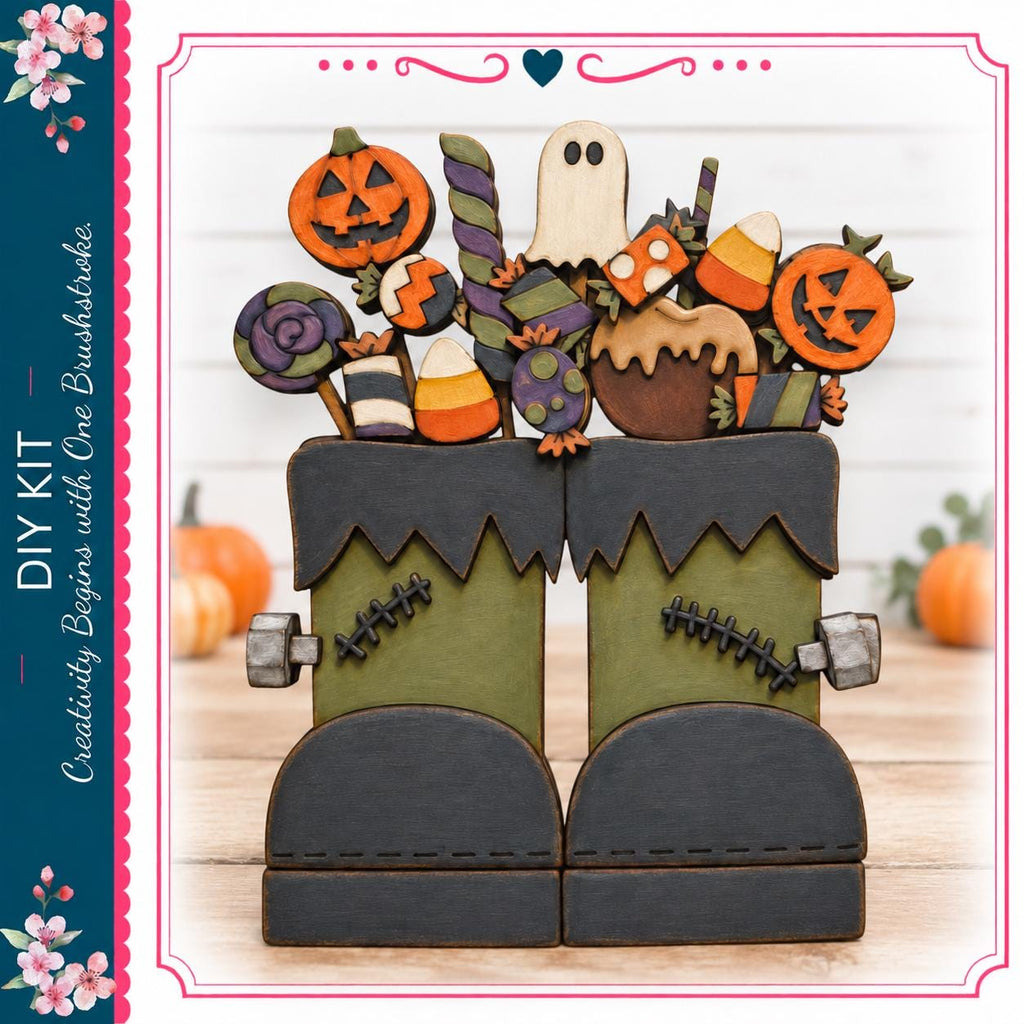 A Halloween-themed DIY kit featuring a pair of green monster boots with various spooky and festive decorations, including a jack-o-lantern, candy corn, and a ghost.