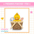 a rubber ducky sitting in a basket of soaps