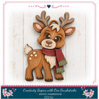 A wooden deer figure wearing a red scarf and antlers, with a smiling expression, is displayed against a white background.