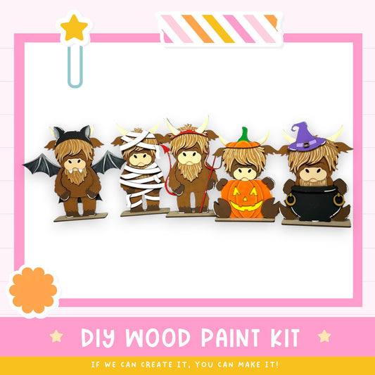 A DIY wood paint kit featuring five cartoon cow characters dressed in Halloween costumes, including bats, mummies, pumpkins, and witches.