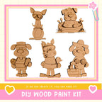 The image is a collage of five wooden animal figurines, including a dog, cat, and other animals, along with a wooden boat and a bird. The text below the image reads "DIY WOOD PAINT KIT" and "If we can create it, you can make it!"
