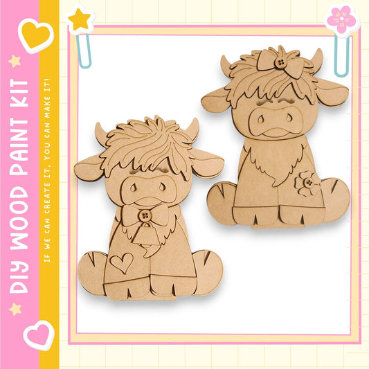 two wooden cutouts of cows, one on the left and one on the right, sitting on the ground.