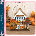 A wooden farm stand with a mushroom, pumpkins, and a tree, surrounded by autumn decorations, is the focus of the image.