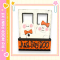 A wooden frame with two ghostly figures wearing orange bows, and the text "Just Say Boo" on the front.