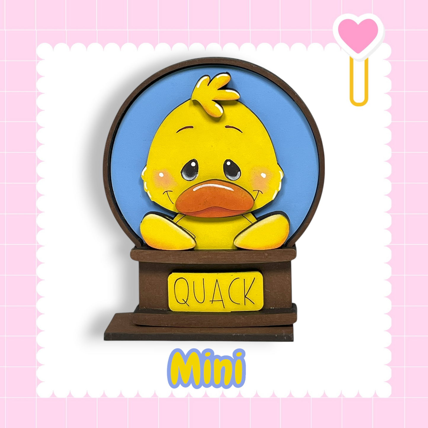 A cute yellow duck with a blue background and the word "QUACK" written on a brown base.